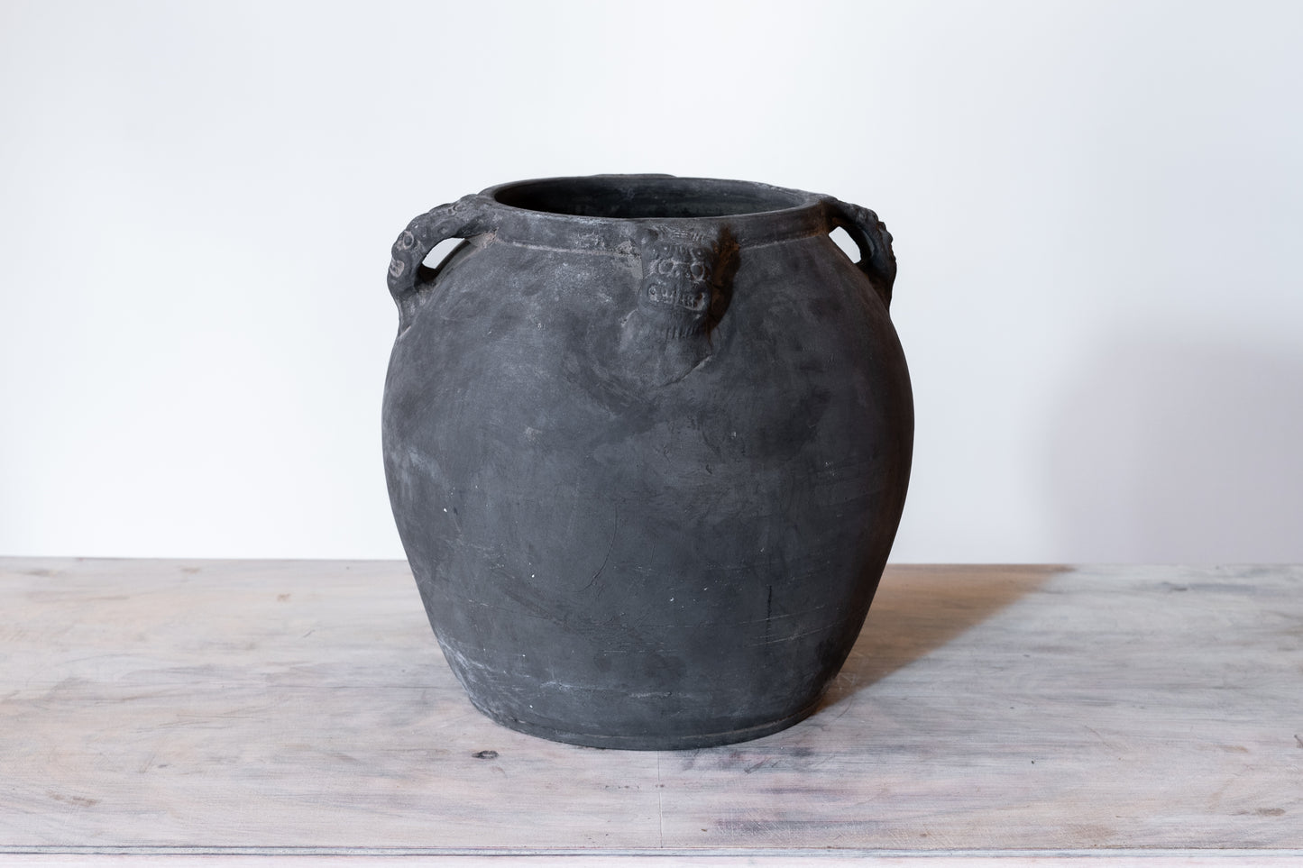 BLACK CERAMIC LION'S HEAD POT, C.1910