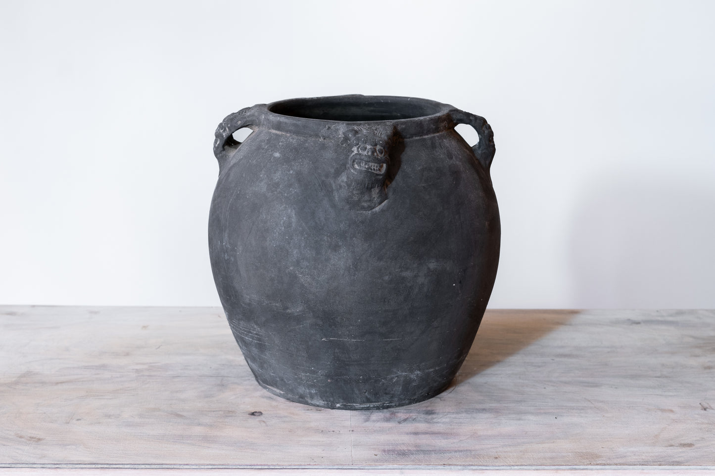 BLACK CERAMIC LION'S HEAD POT, C.1910